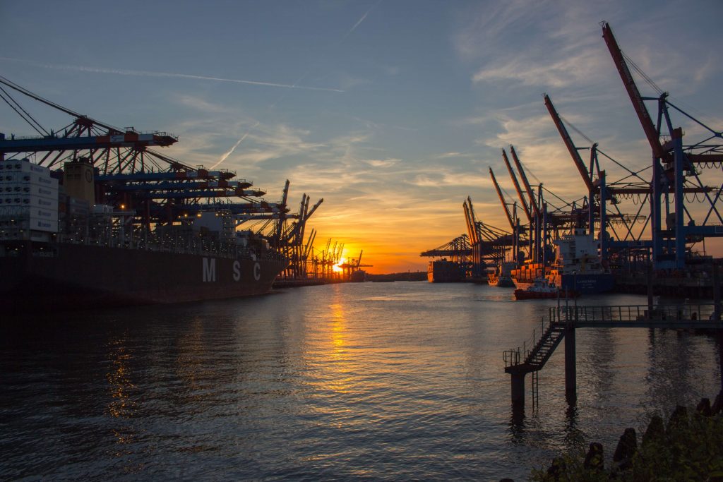 summer shipping tips and port in front of the sunset 