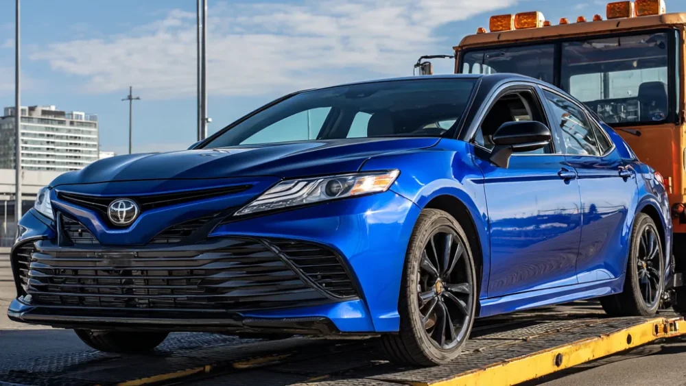 Toyota being towed on a flatbed